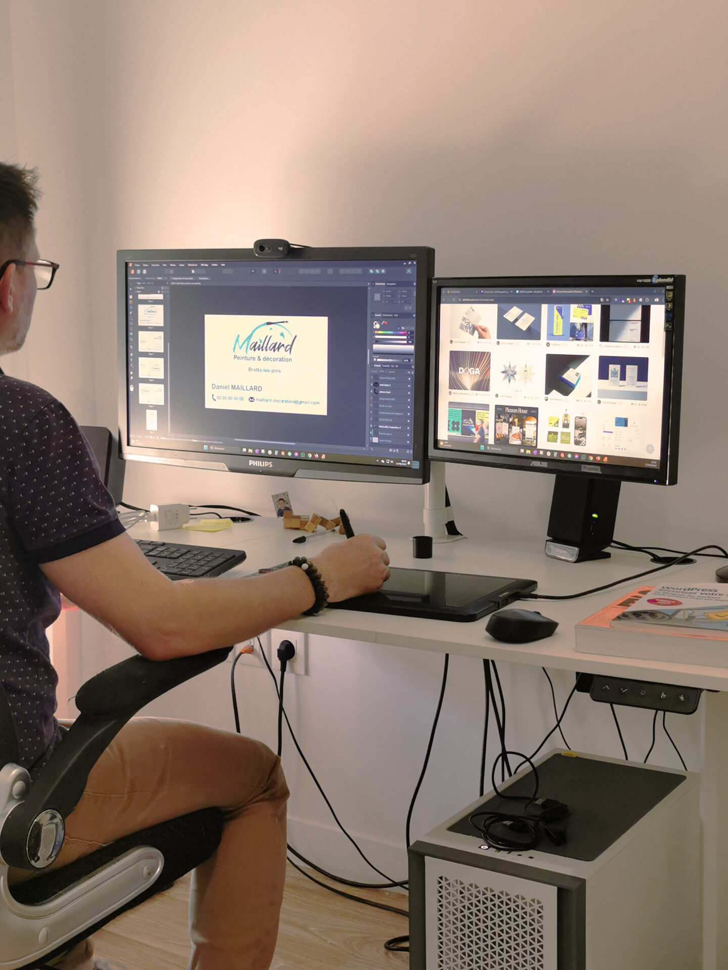 Une personne en pleine création graphique devant son ordinateur, assis à son bureau.